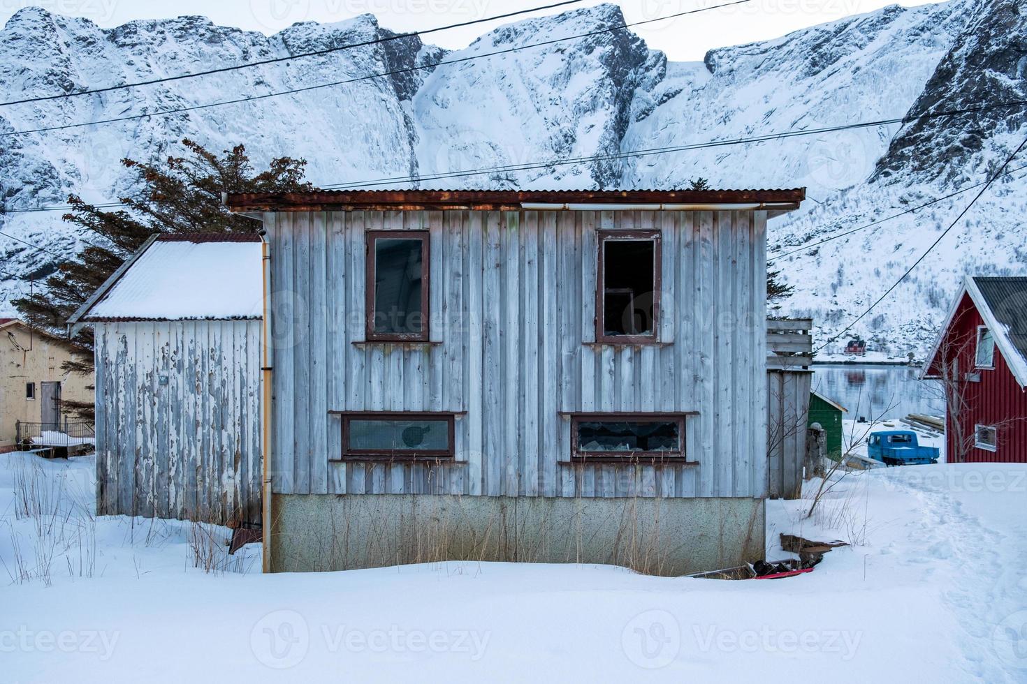 Abandoned wooden house with windows glass cracked photo