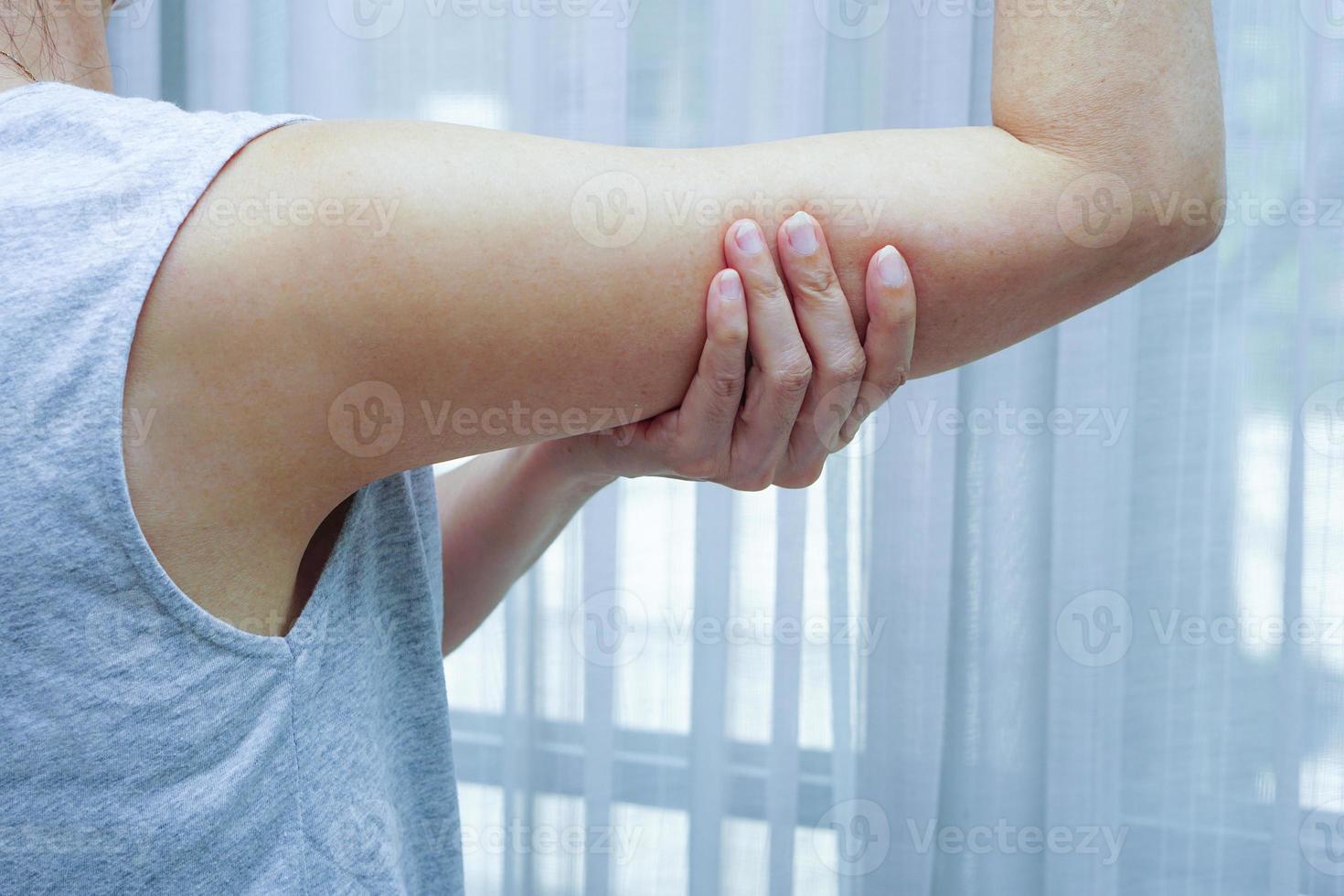 Woman with pain in shoulder and upper arm. photo