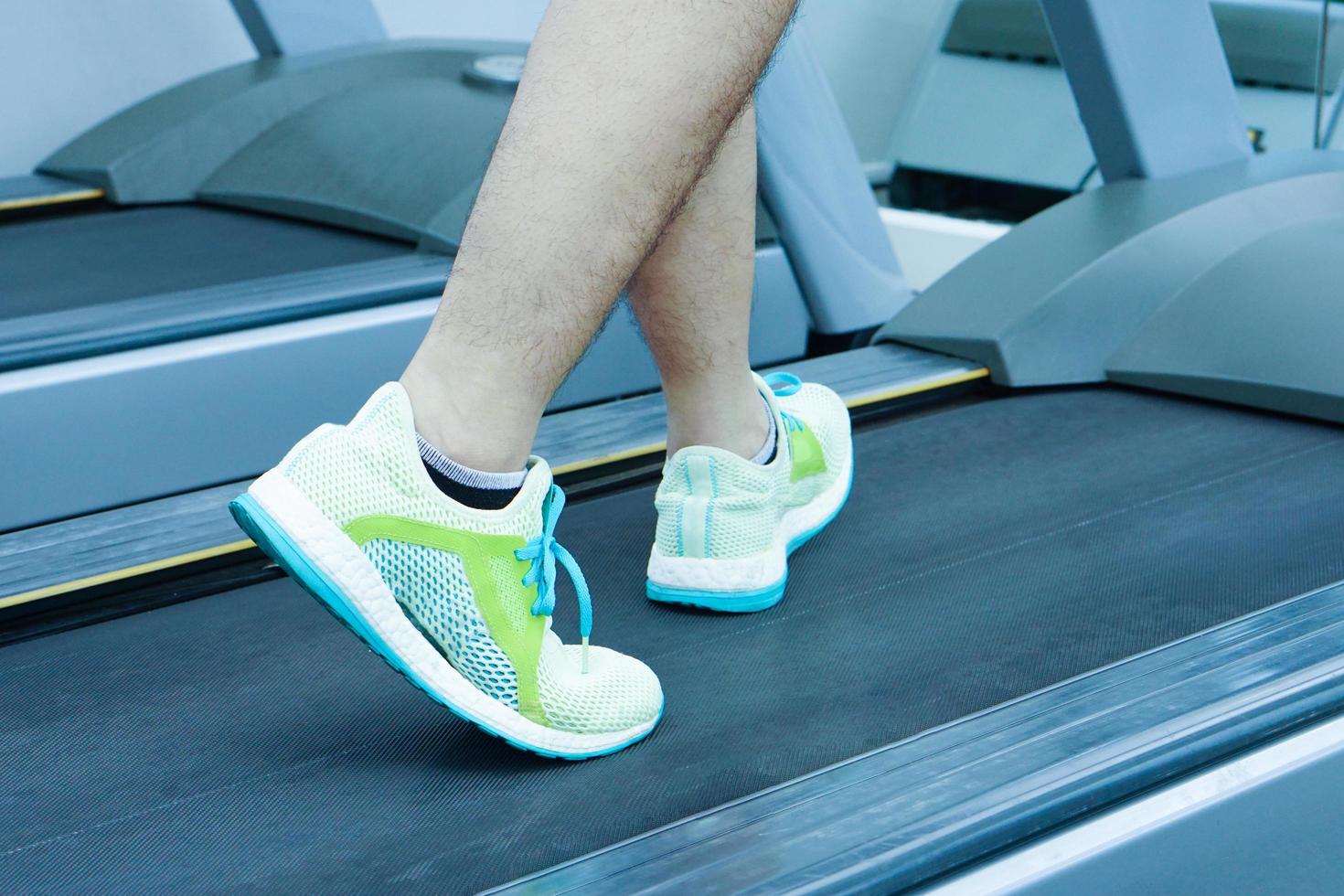 hombre haciendo ejercicio en caminadora en el gimnasio. concepto de salud y pérdida de peso. foto