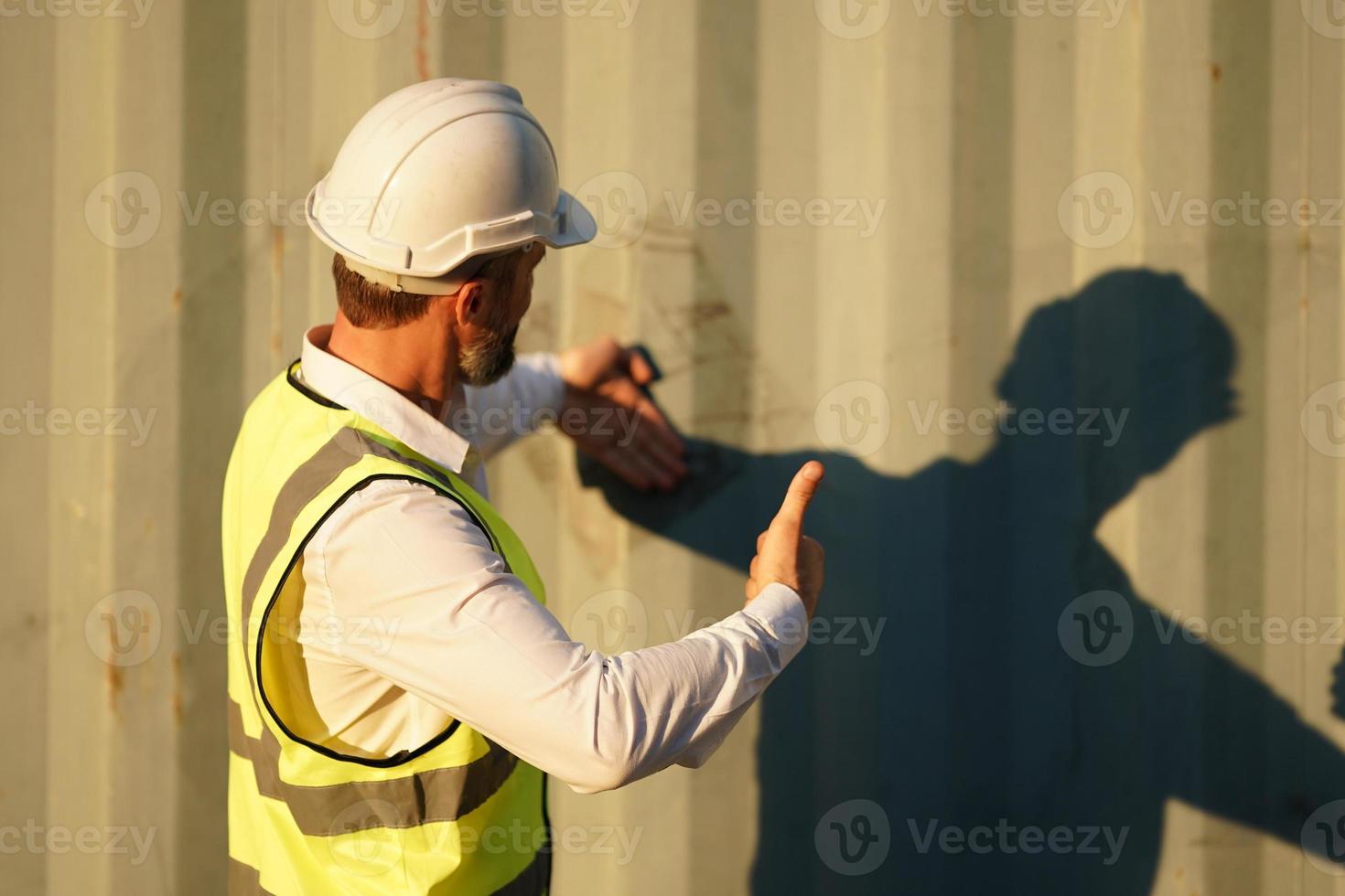 Foreman checking containers in the terminal, at import and export business logistic company. photo