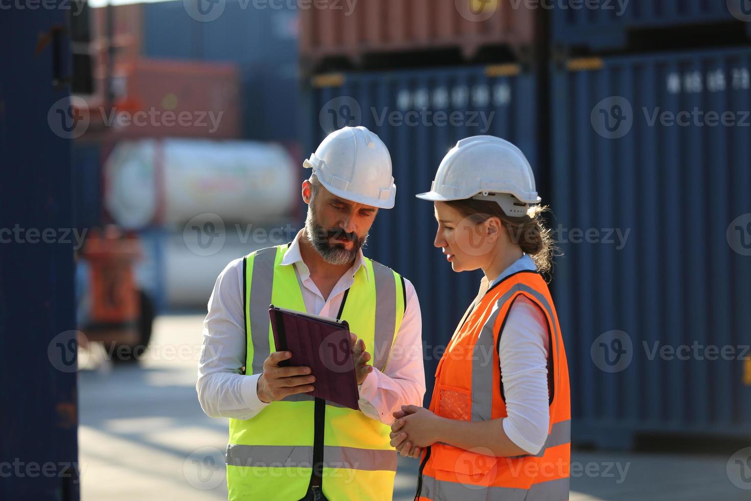 Foreman checking containers in the terminal, at import and export business logistic company. photo