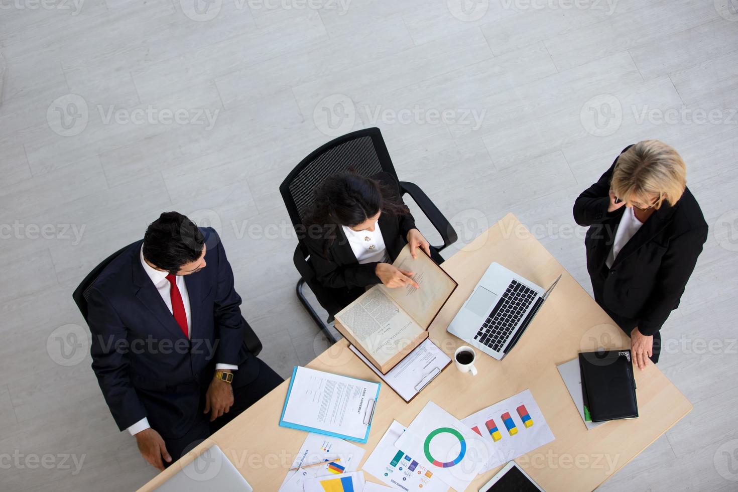 Top view on a group of businessman and businesswoman having a meeting and making a business commitment. photo