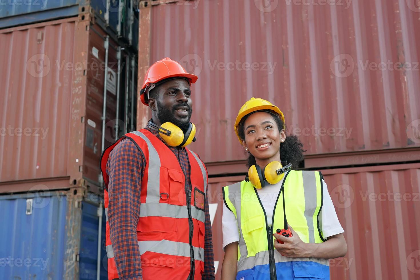 Foreman control loading Containers box from Cargo freight ship for import export. photo