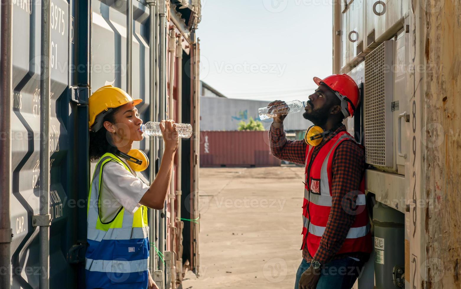 Foreman control loading Containers box from Cargo freight ship for import export. photo