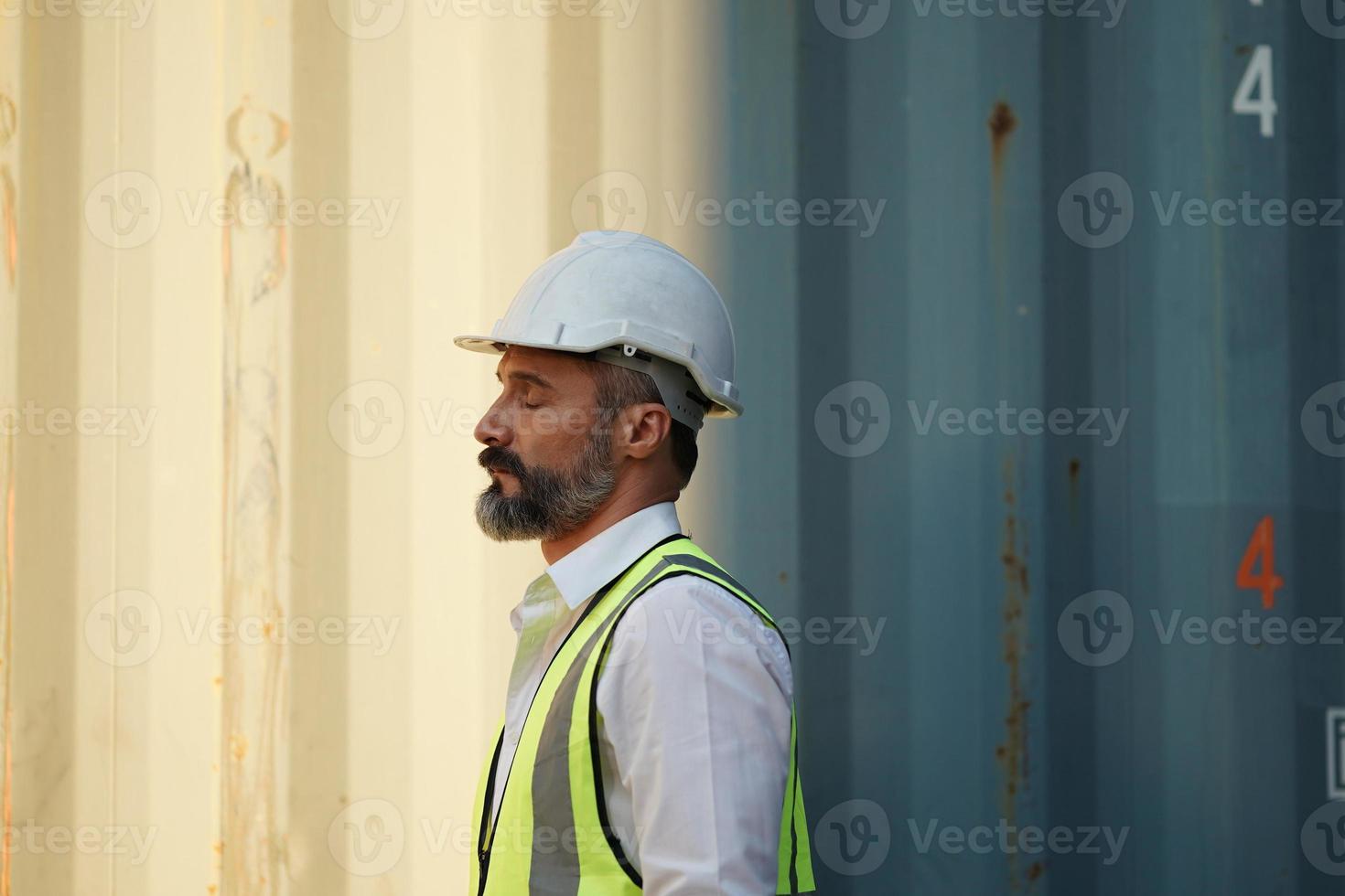 Foreman checking containers in the terminal, at import and export business logistic company. photo
