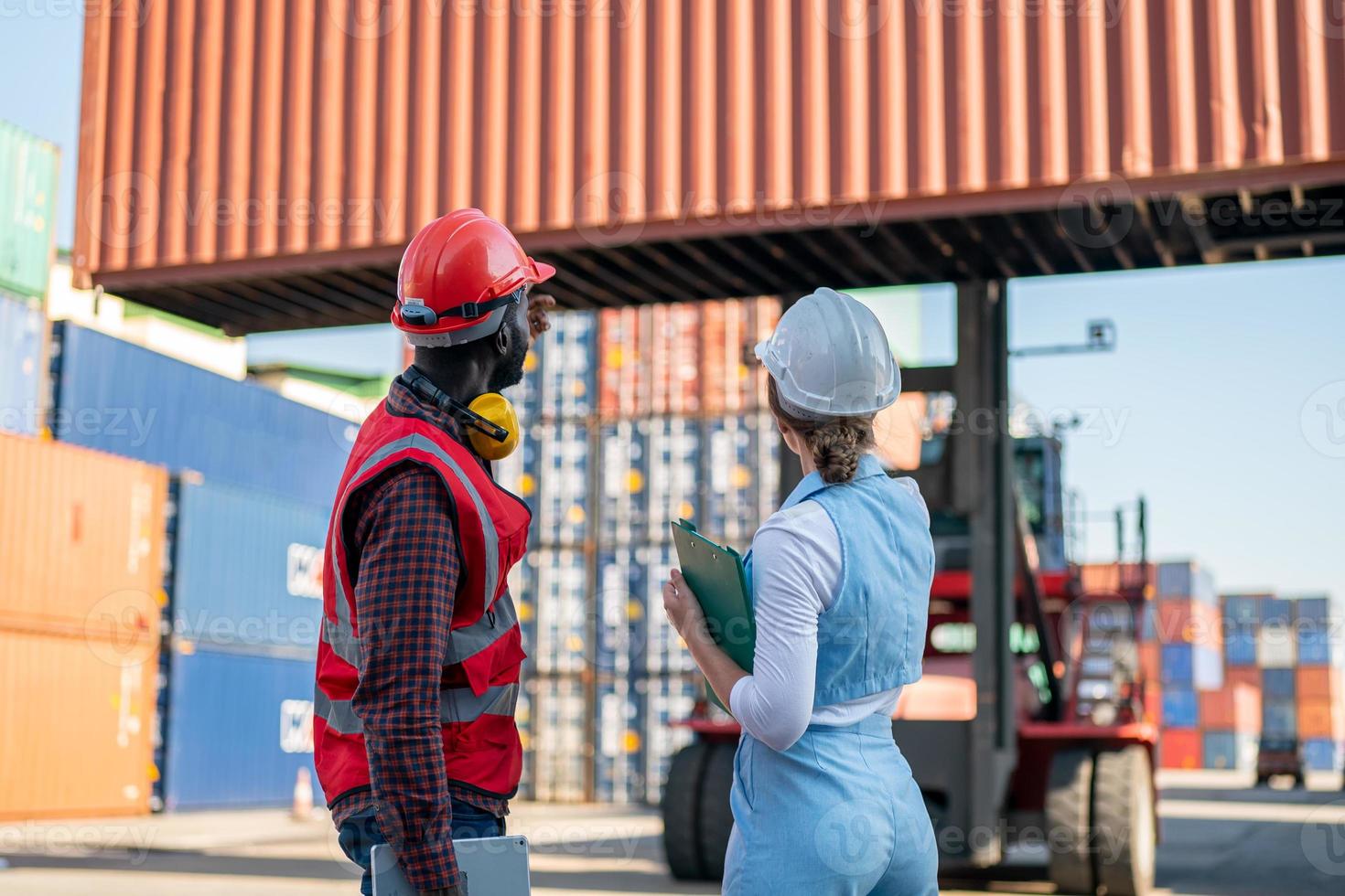 Foreman checking containers in the terminal, at import and export business logistic company. photo