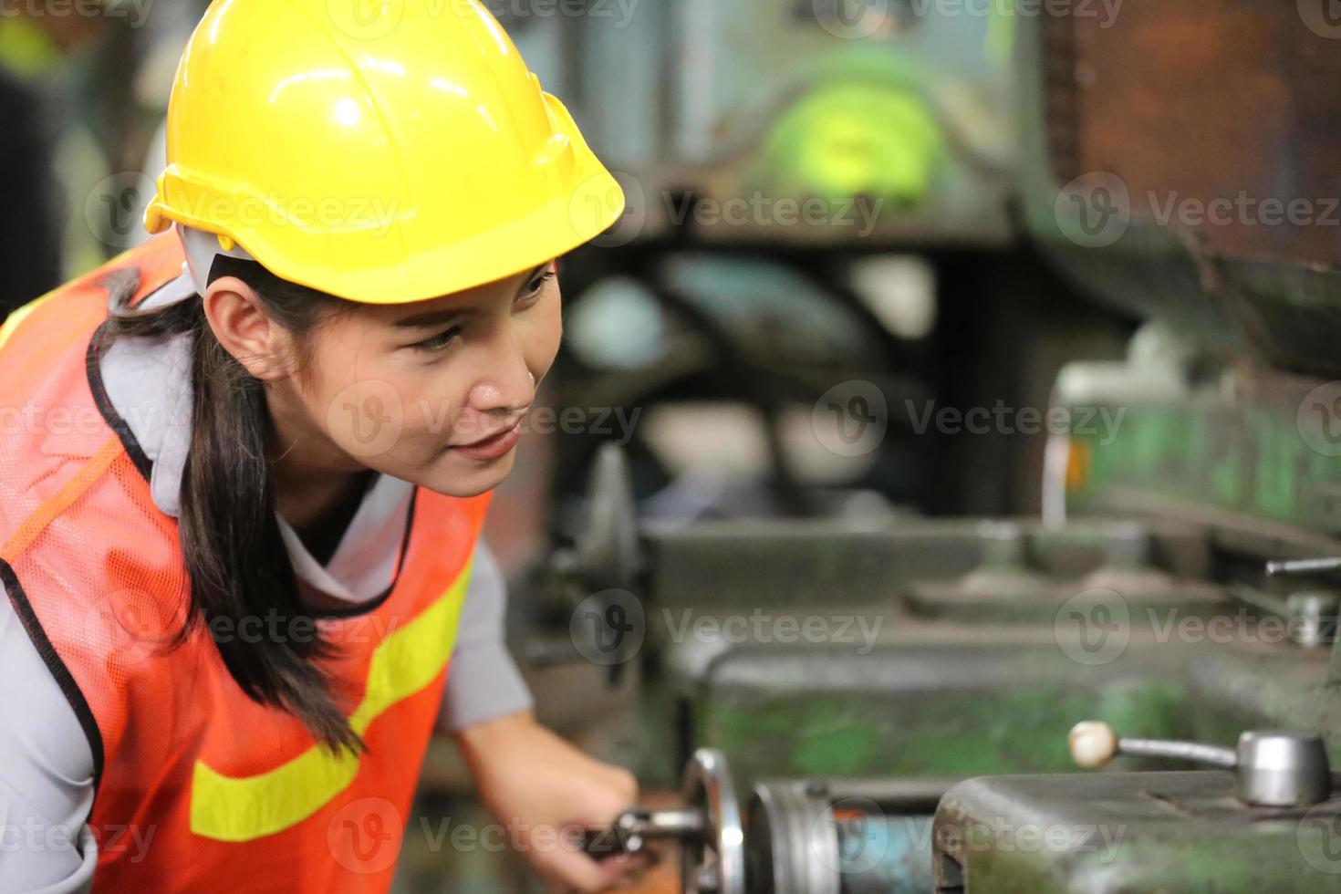 Female Worker work at factory site check up machine in products line or products in site. Engineer or Technician checking Material or Machine on Plant. Industrial and Factory. photo