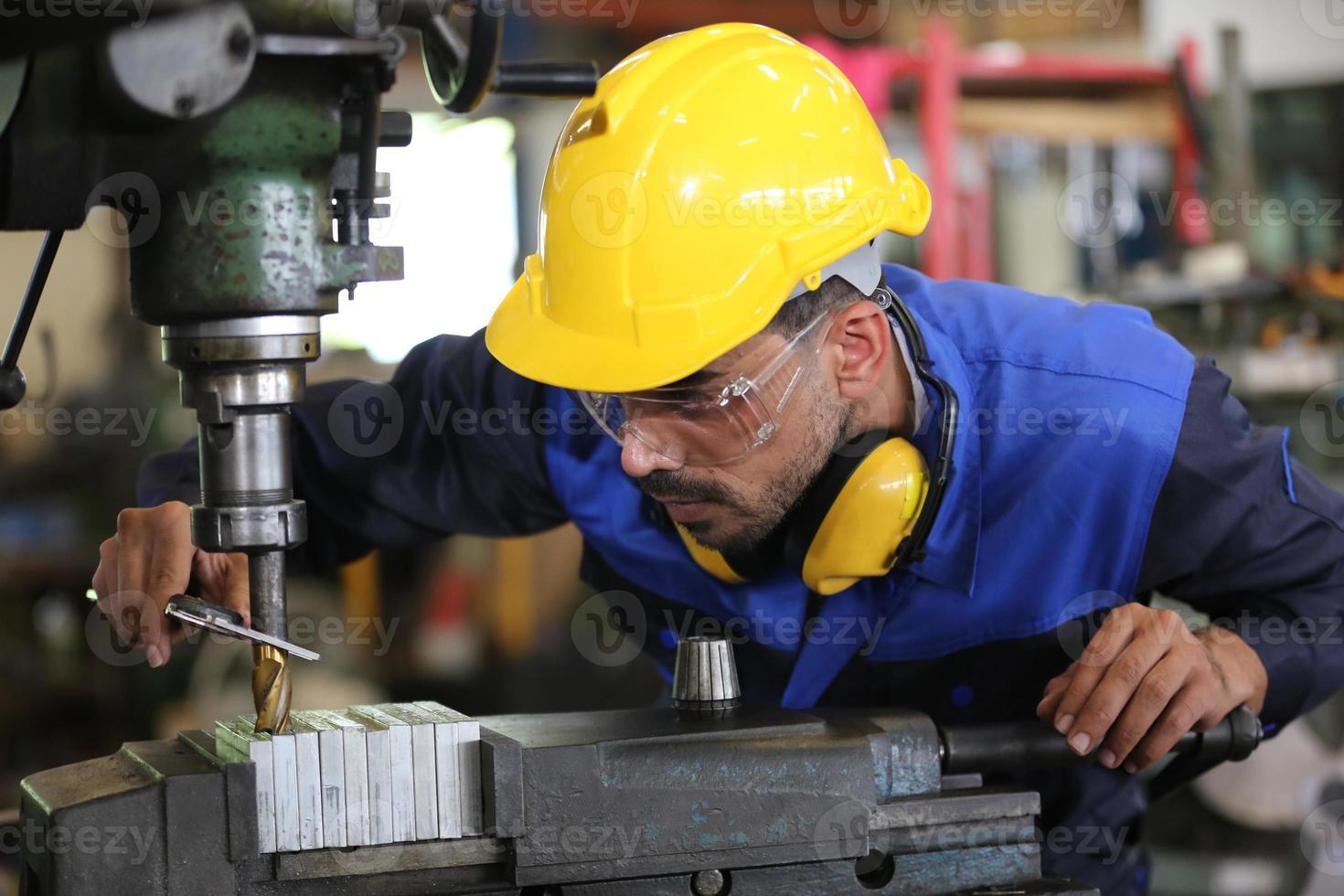 Professional industrial factory employee working with machine part, checking and testing industrial equipment and robot arms in large Electric electronics wire and cable manufacturing plant factory photo