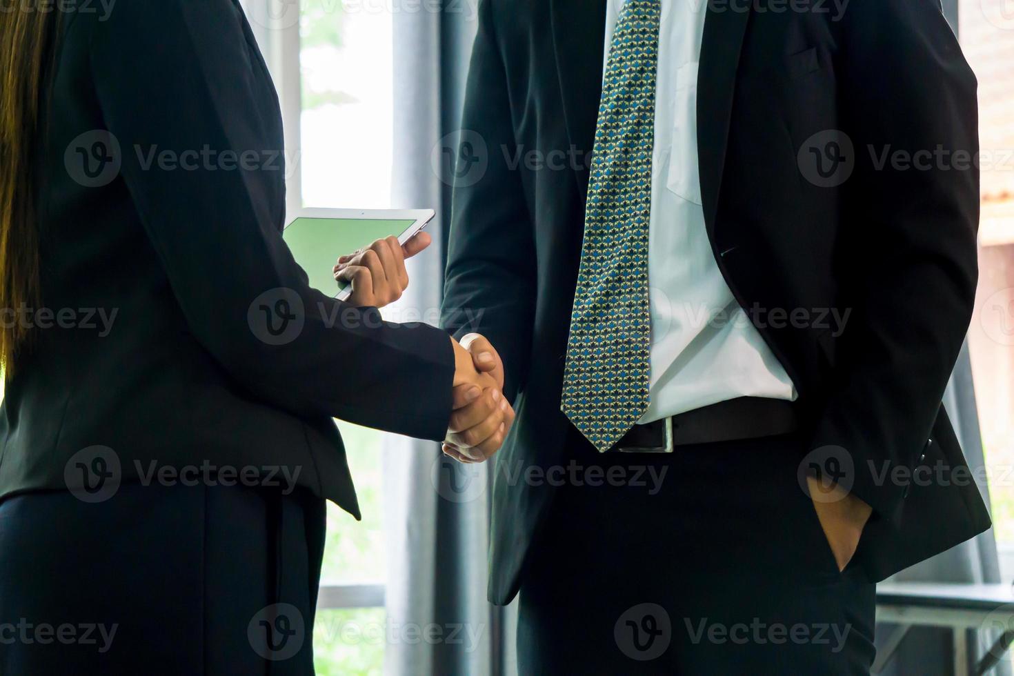 Business people shaking hands after successful negotiations photo