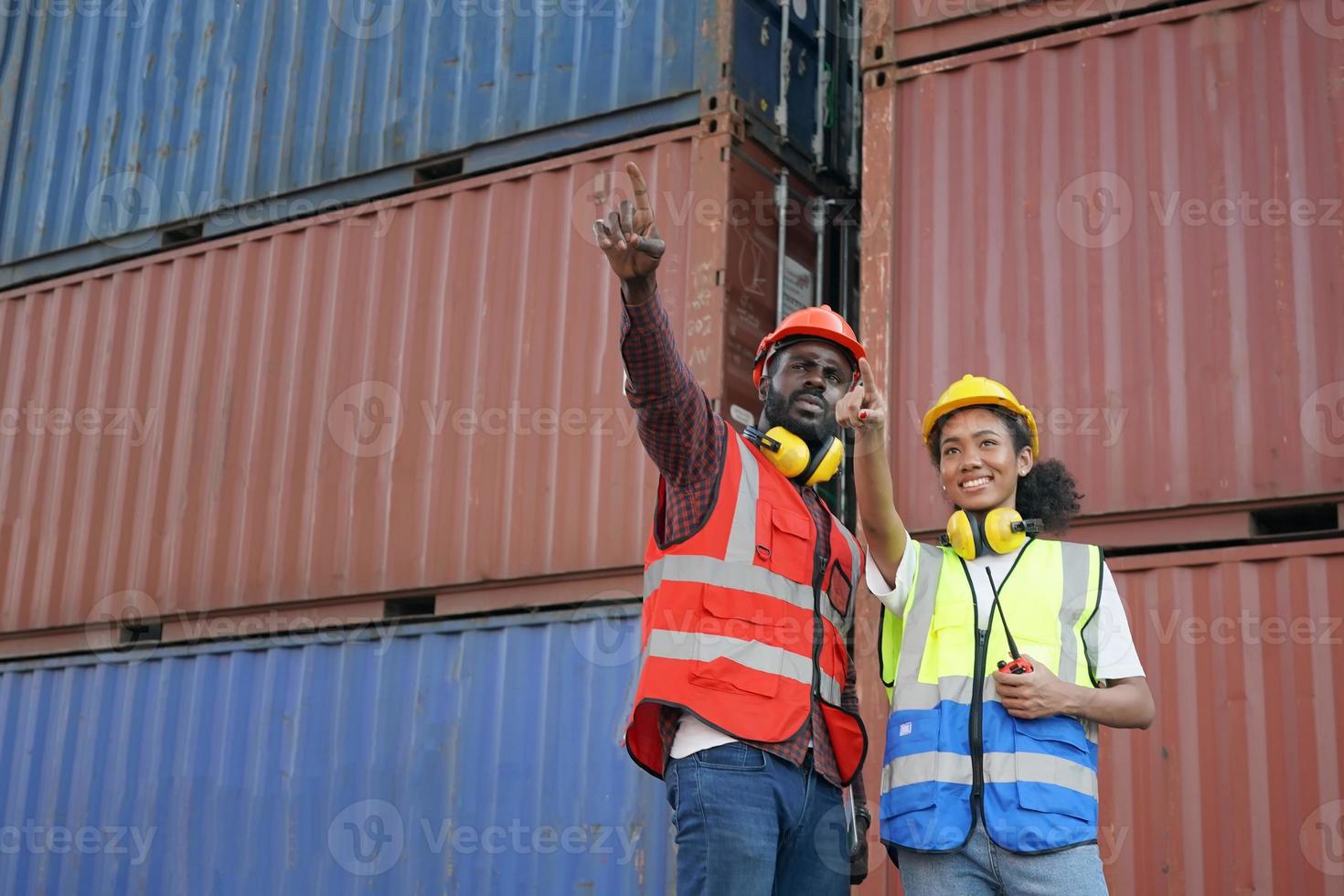 Foreman control loading Containers box from Cargo freight ship for import export. photo