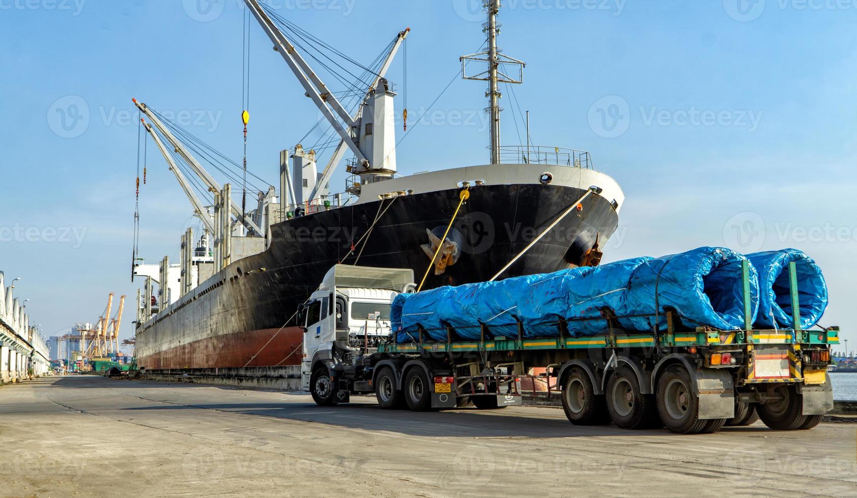 Container loading in a Cargo freight ship with industrial crane. Container ship in import and export business logistic company. Industry and Transportation concept. photo