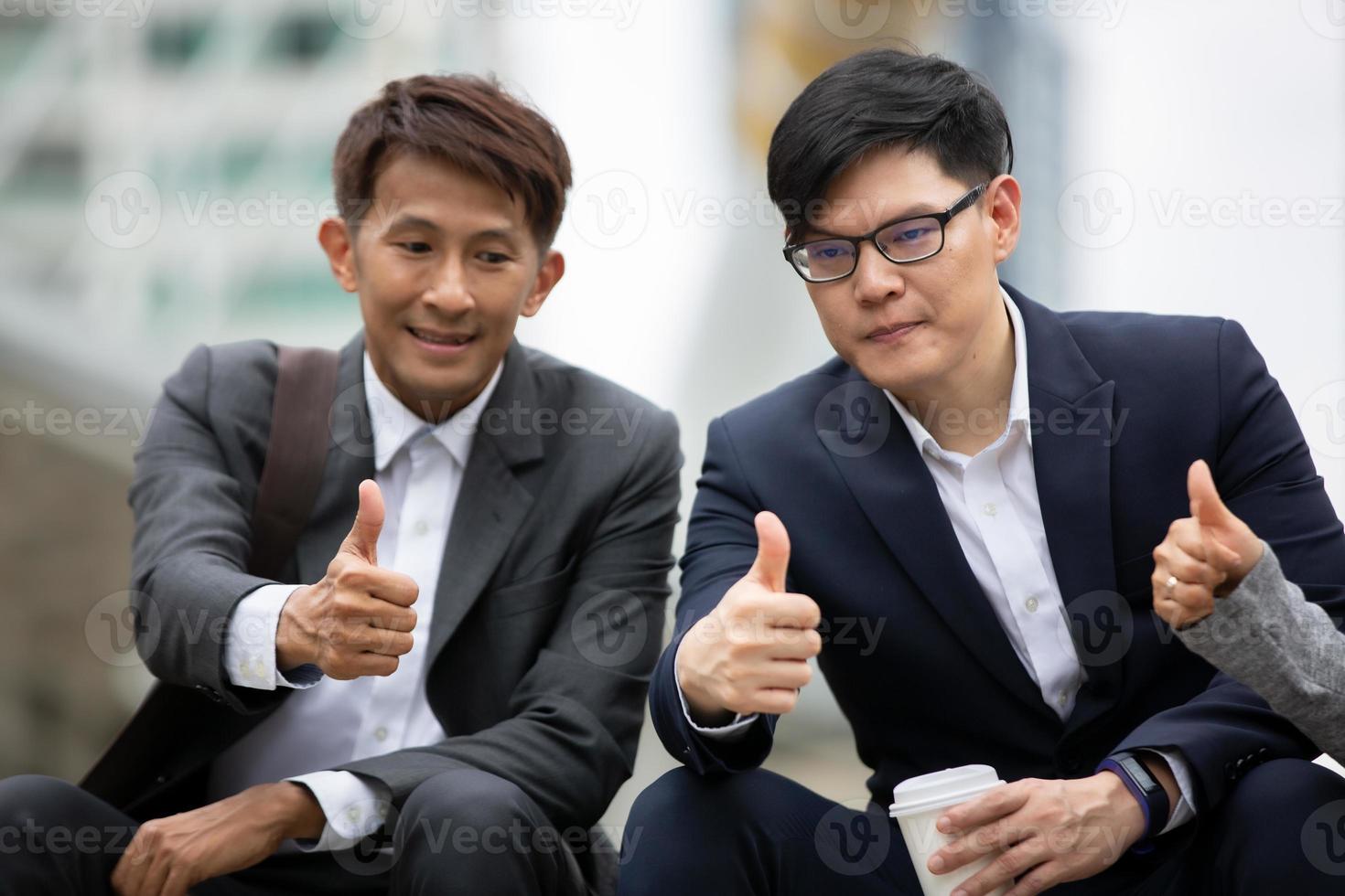 Successful business people standing together widen out showing strong relationship of worker community. A team of businessman and businesswoman expressing a strong group teamwork at the modern office. photo