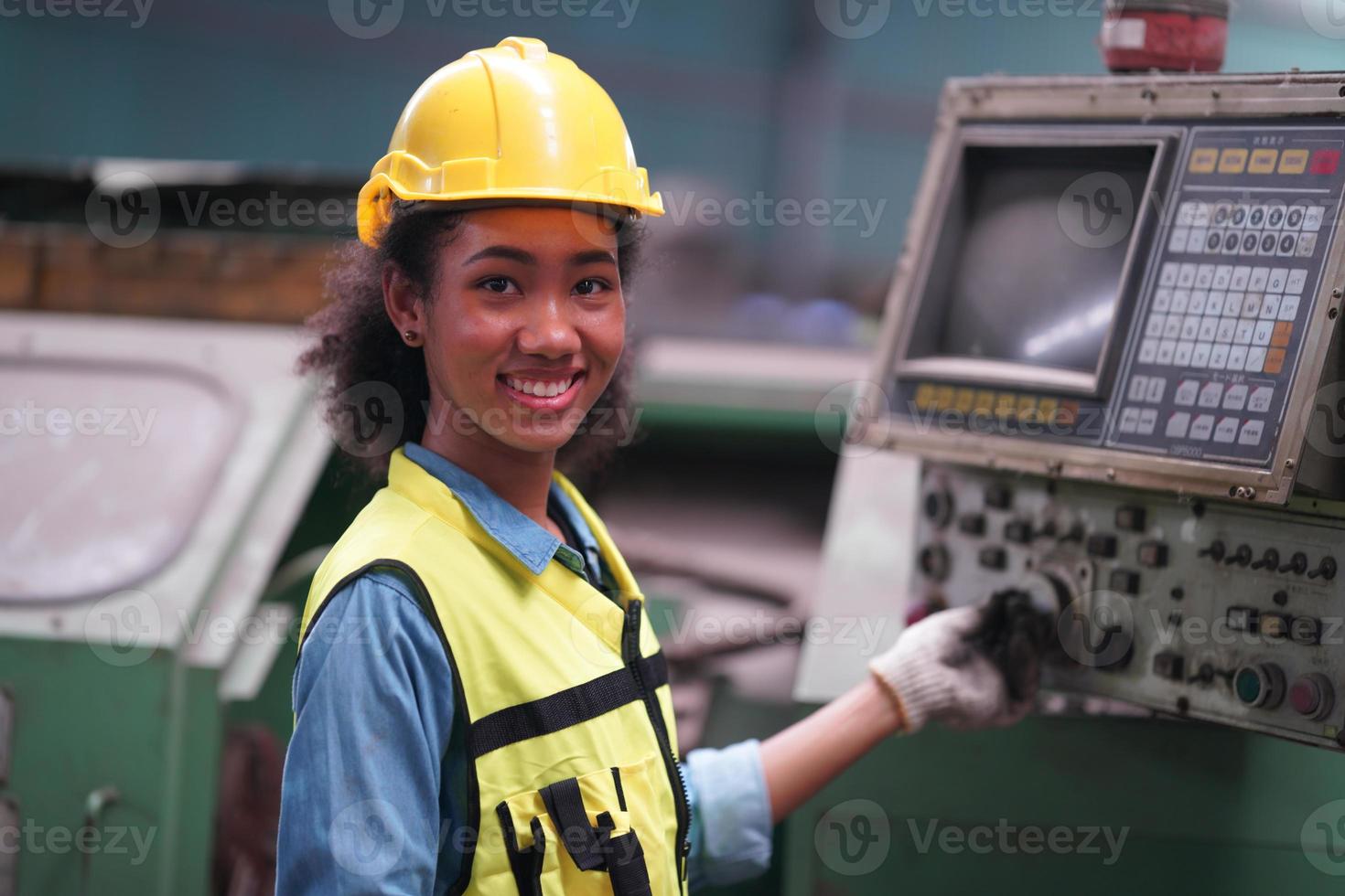 Female Maintenance Engineers is working in front of the automated CNC machinery repair on a maintenance checklist at the production line. photo