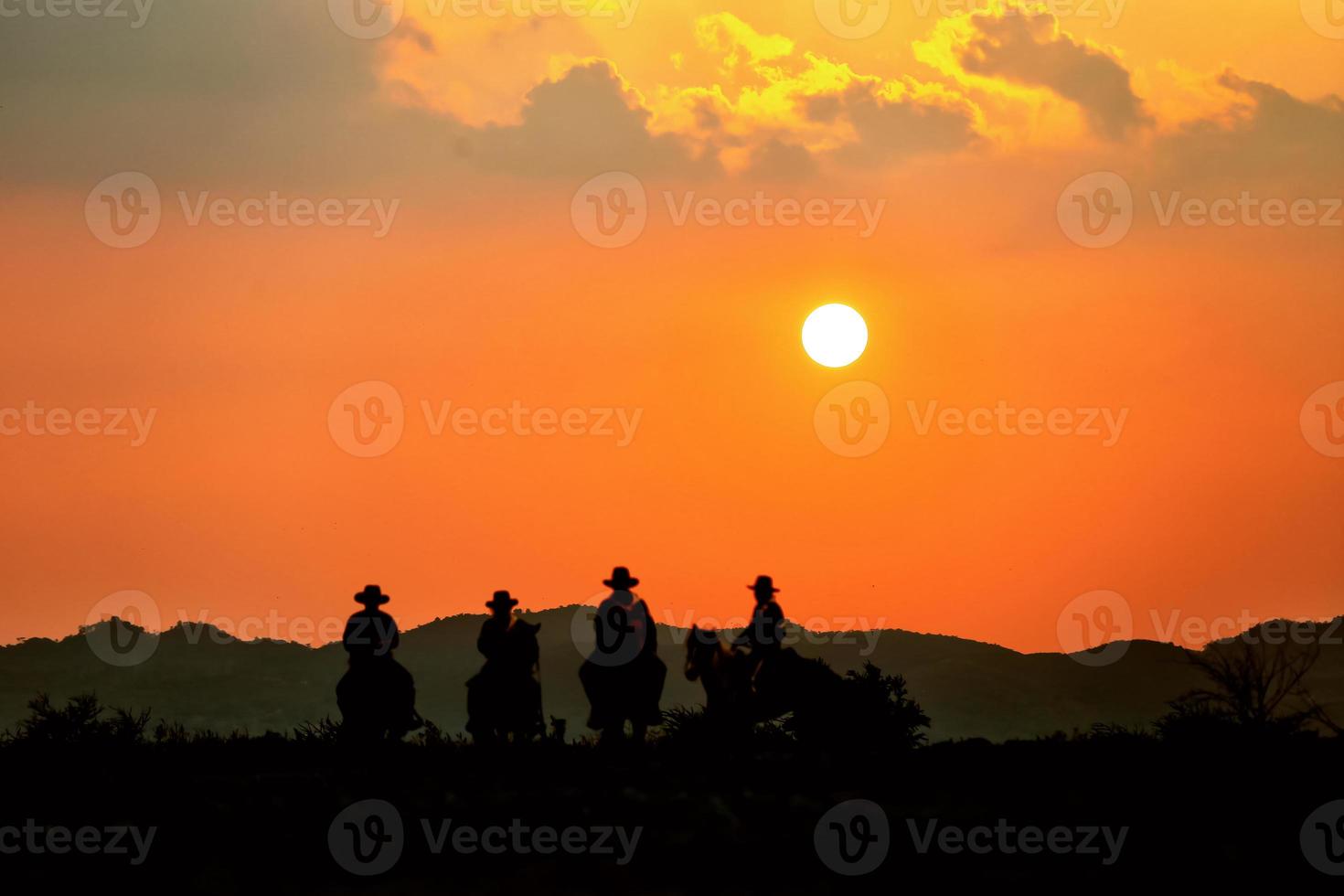 silhouette Cowboy on horseback against a beautiful sunset, cowboy and horse at first light, mountain, river and lifestyle with natural light background photo