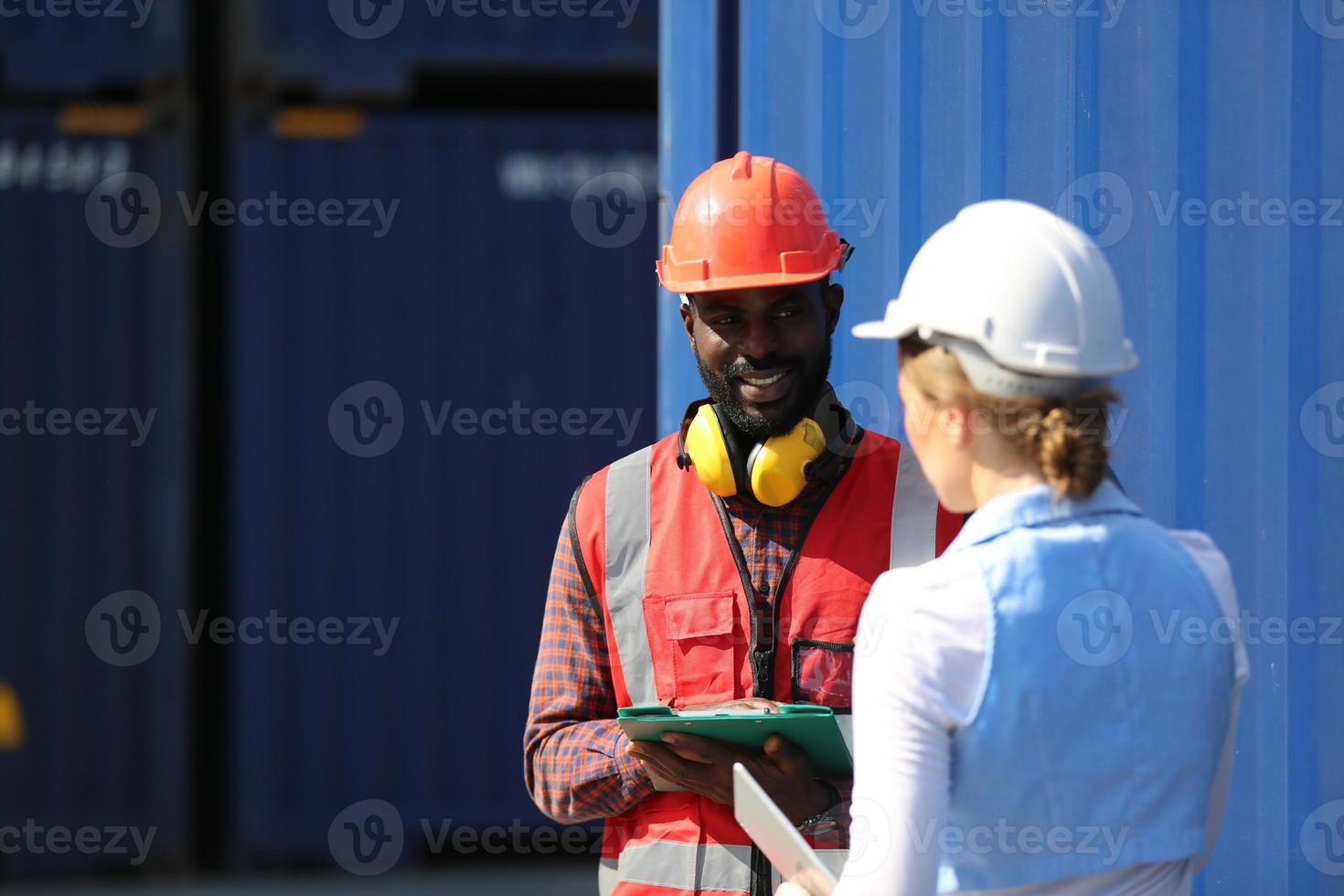 Foreman control loading Containers box from Cargo freight ship for import export. photo