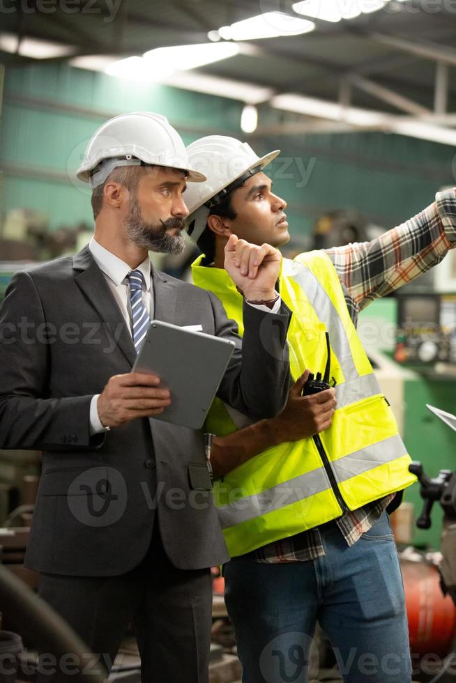 Worker work at factory site check up machine in products line or products in site. Engineer or Technician checking Material or Machine on Plant. Industrial and Factory. photo