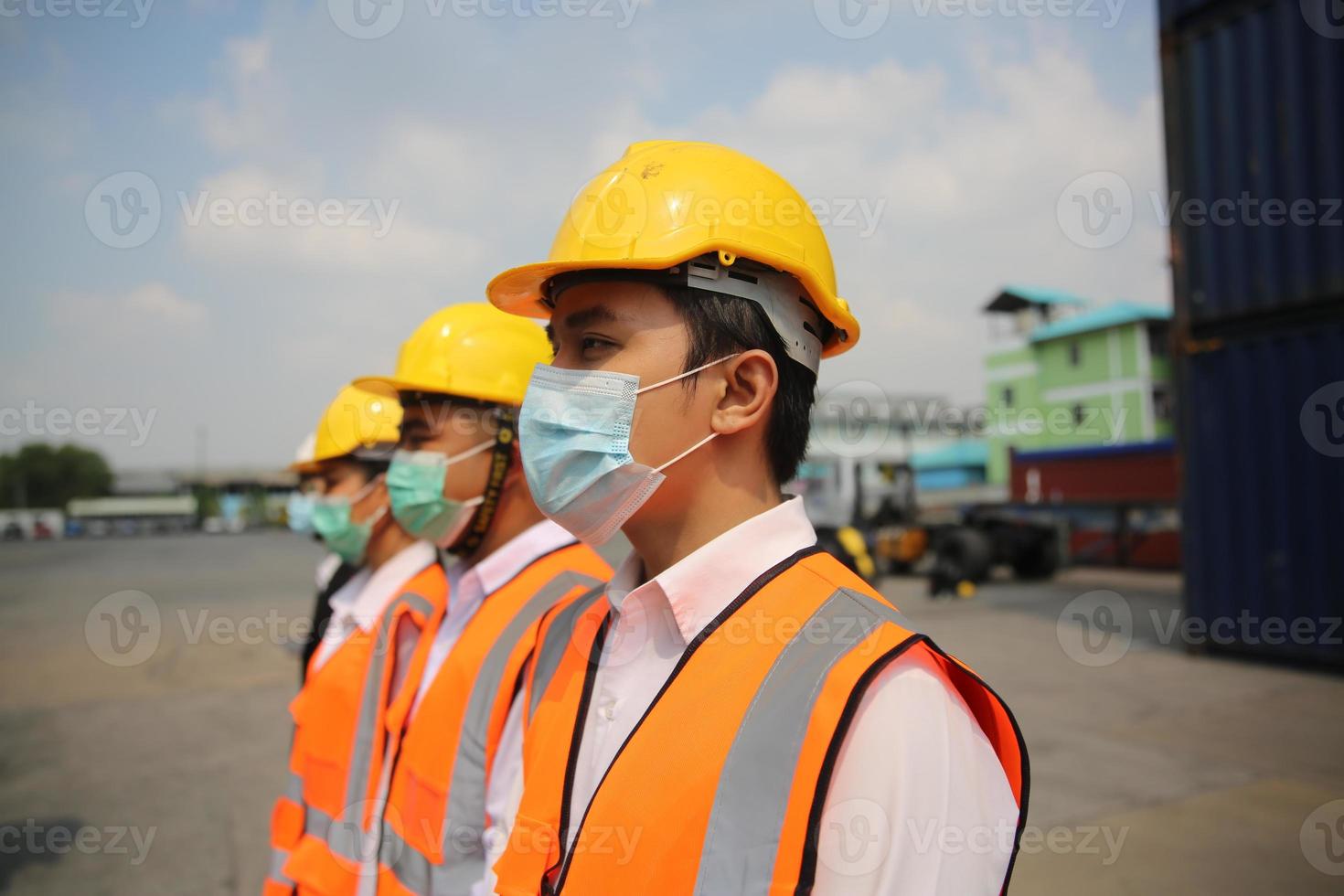 Group of industry workers control loading containers in the container terminal, during covid-19 check. photo