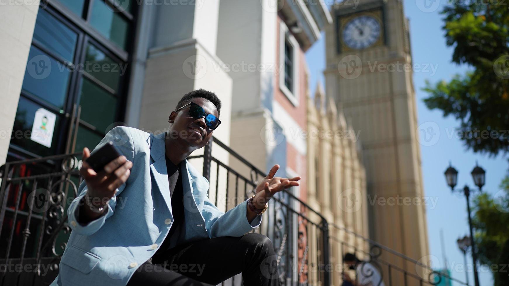 Afro American man having fun walking in city center - Happy young guy enjoying time a sunset outdoor - Millennial generation lifestyle and positive people attitude concept photo