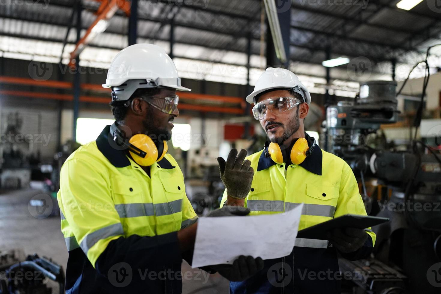 Maintenance Engineers is working in front of the automated CNC machinery repair on a maintenance checklist at the production line. photo