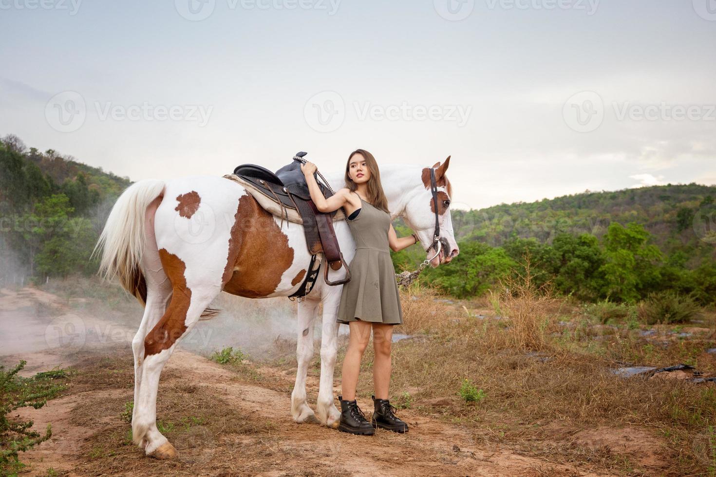 Young woman with her horse in evening sunset light. Outdoor photography with fashion model girl. Lifestyle mood photo