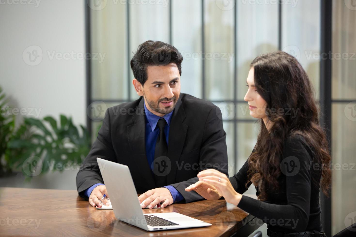 Two business people collaborating in office or Multiethnic business people in meeting. photo