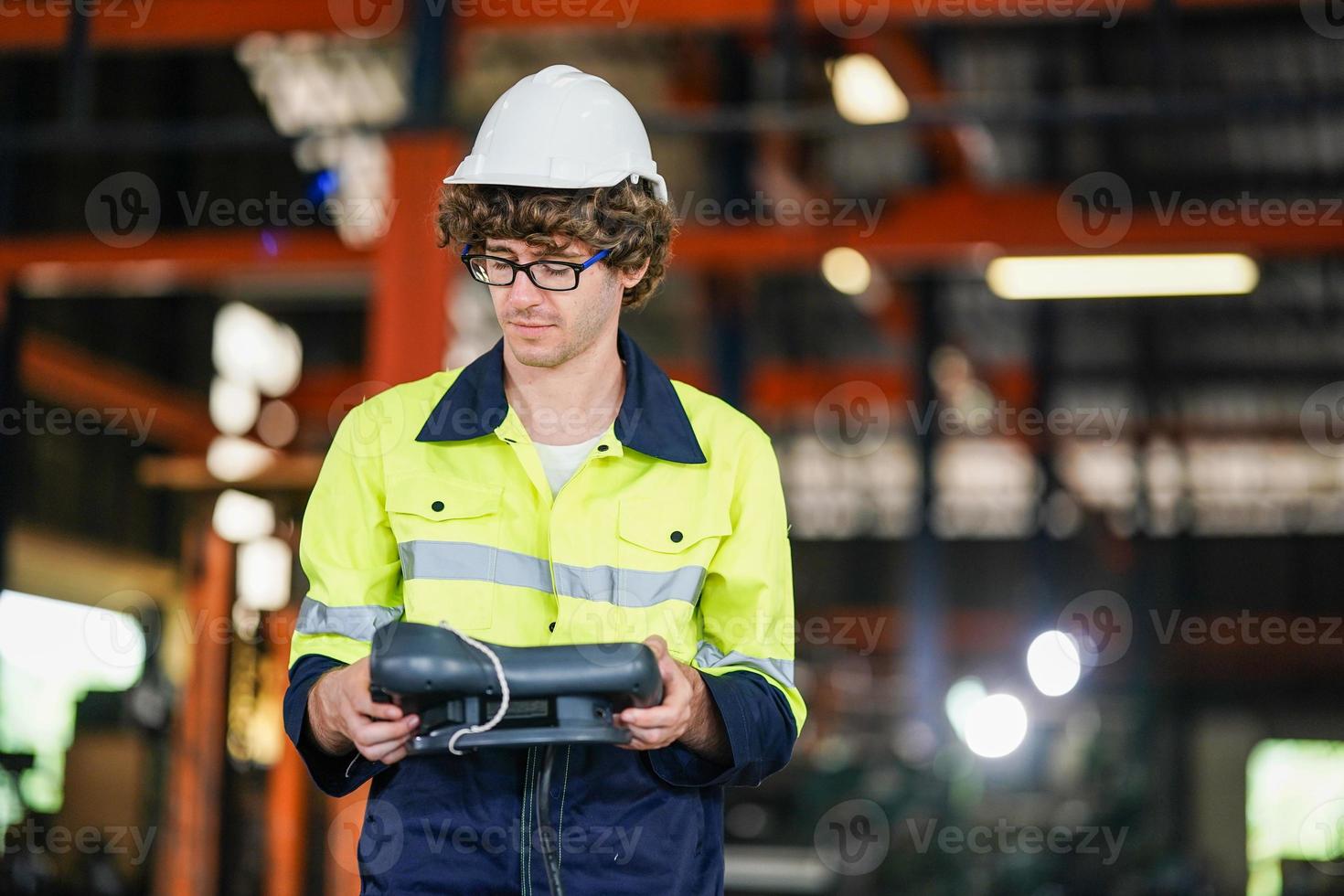 engineer checking control panel and teaching new Automatics robot arm and operating control machine in factory. photo