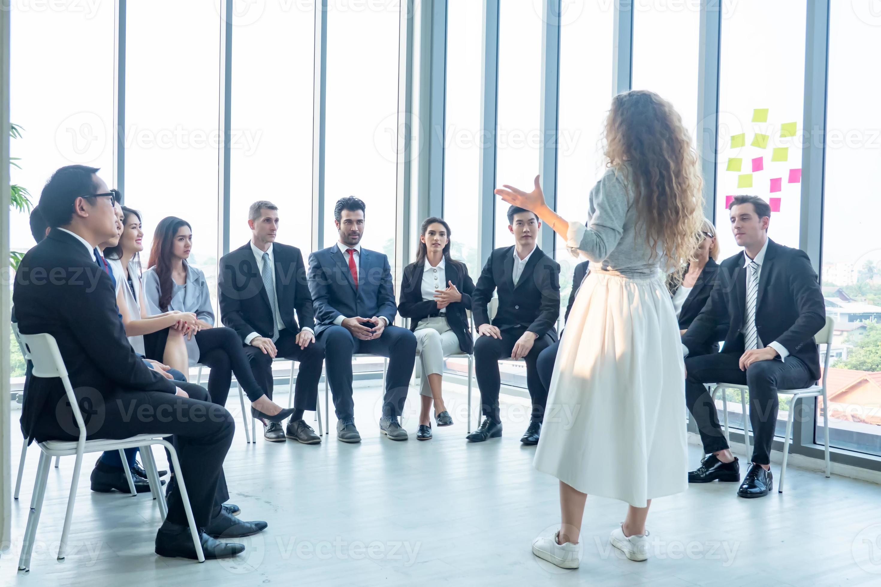 Speaker giving presentation in hall. Audience or conference hall. Rear