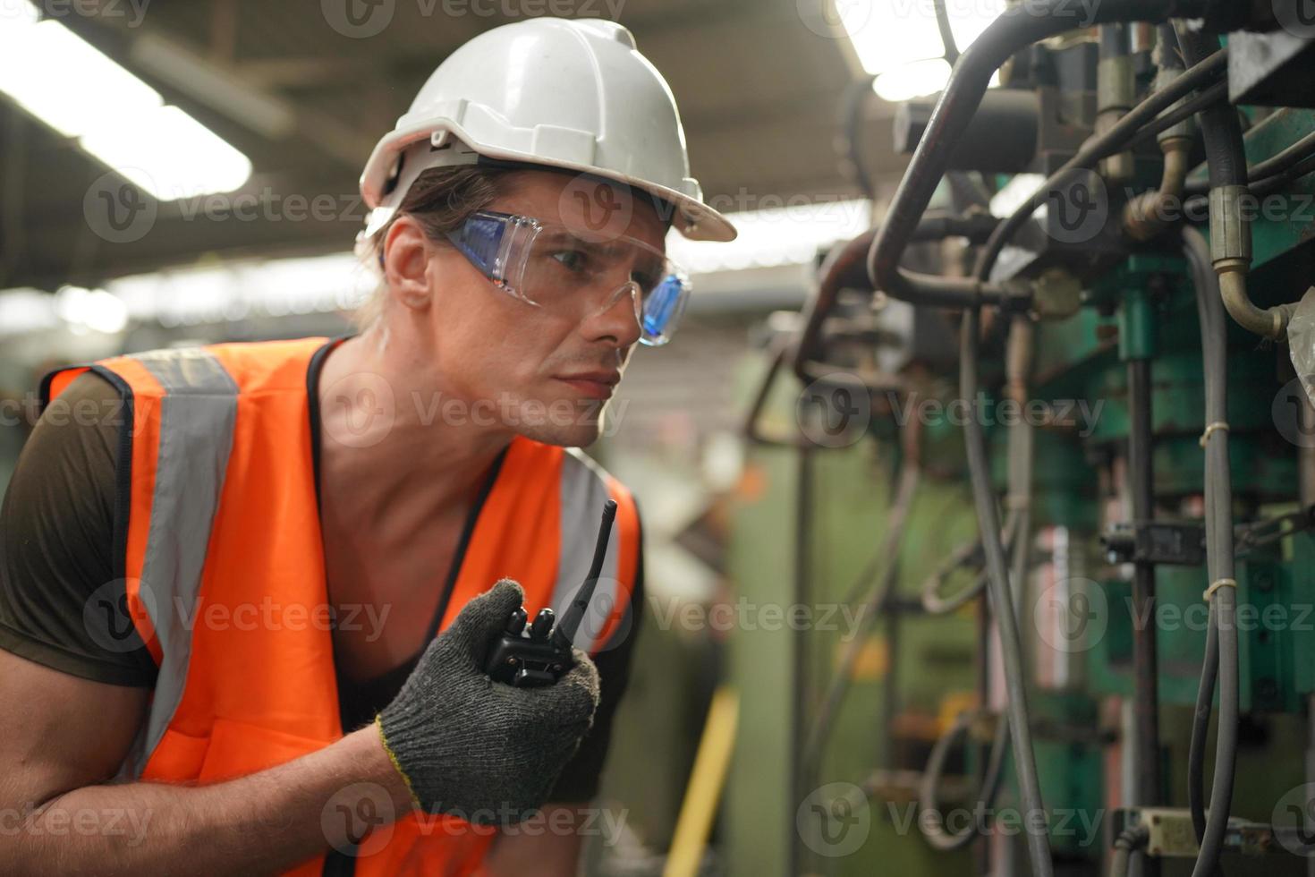 Maintenance Engineers is working in front of the automated CNC machinery repair on a maintenance checklist at the production line. photo