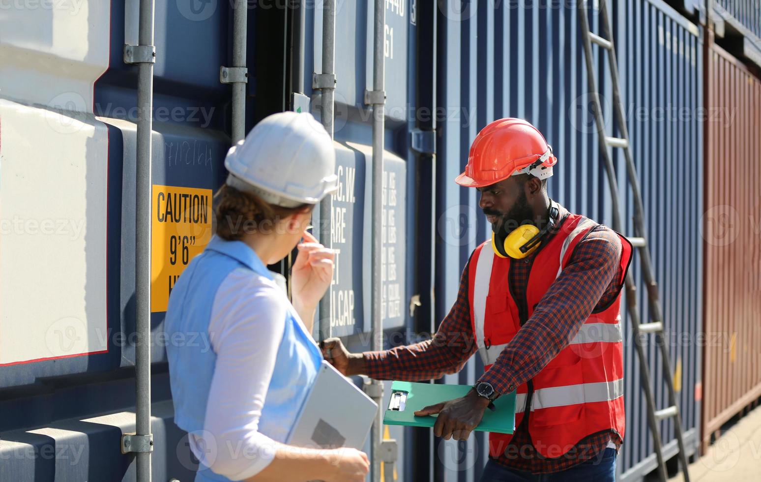 Foreman checking containers in the terminal, at import and export business logistic company. photo