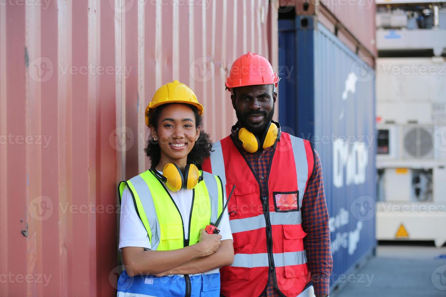 Foreman control loading Containers box from Cargo freight ship for import export. photo