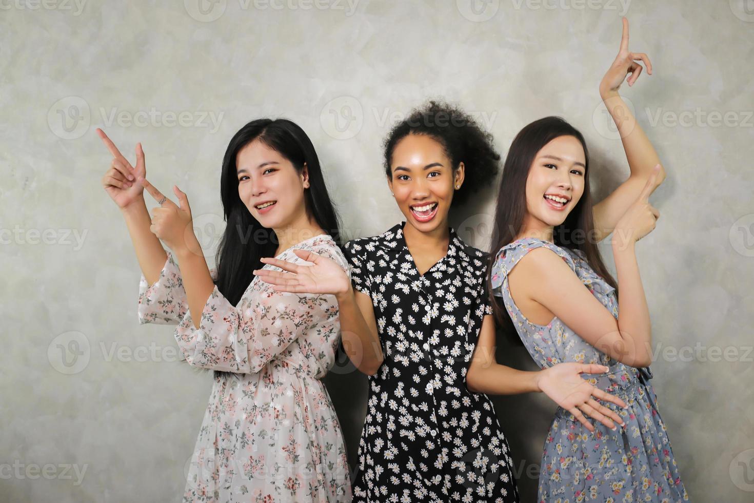 Close up indoor lifestyle portrait of three funny young friends have fun and pretending faces. Home party mood. International Women's Day. Group of three happy young women having smiling. generation Z photo