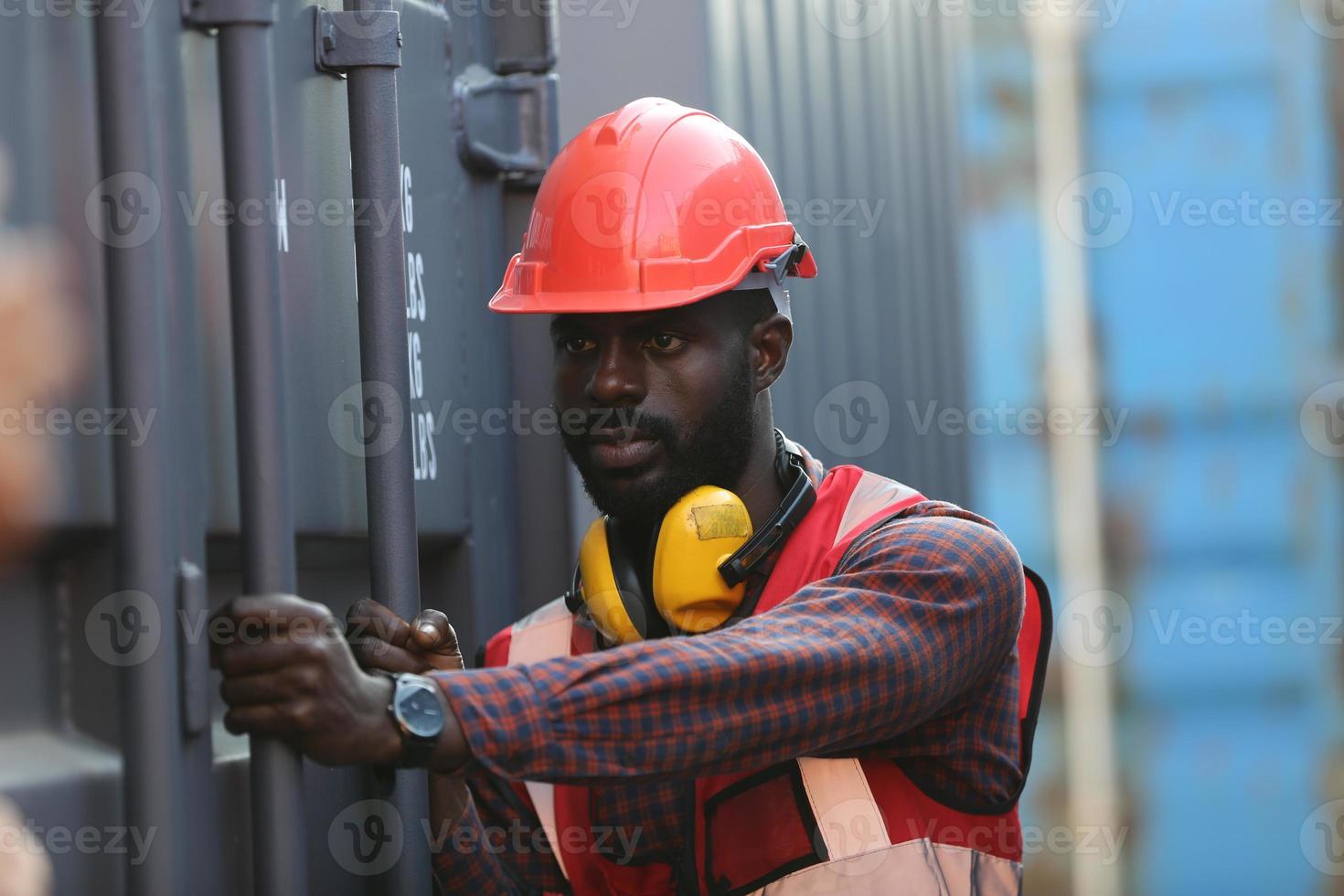 Engineer or supervisor checking and control loading Containers box from Cargo at harbor. Foreman control Industrial Container Cargo freight ship at industry. Transportation and logistic concept. photo