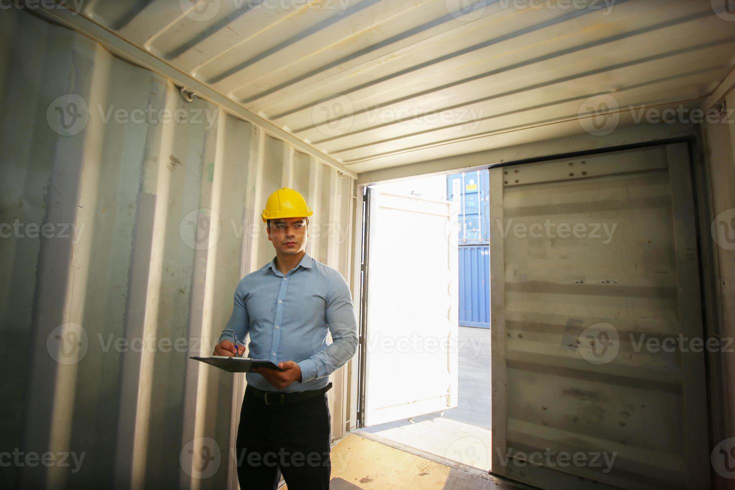 Foreman control loading Containers box from Cargo freight ship for import export. photo