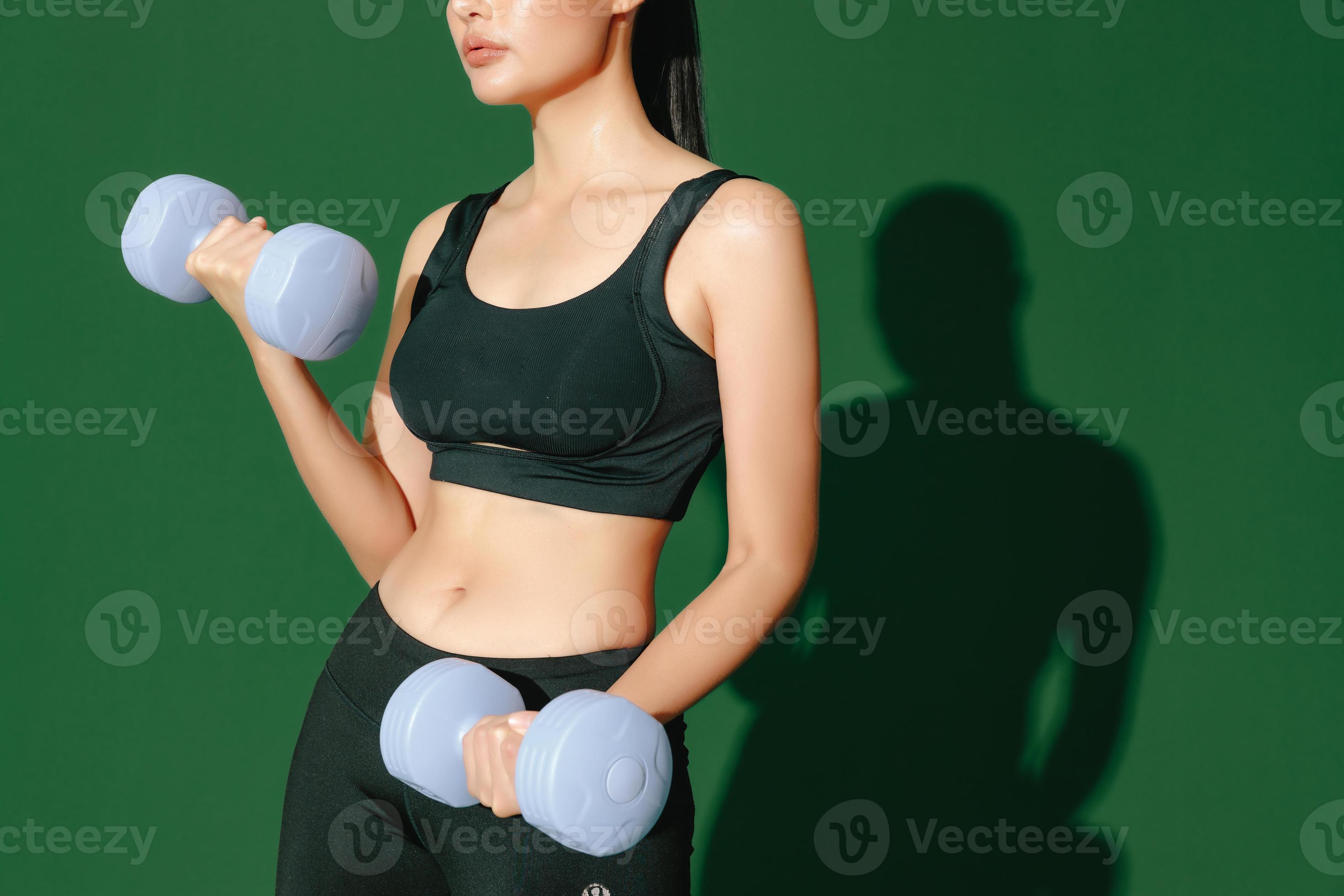 crop close up body of young Asian sports woman does exercises isolated on  green background. Fitness girl in sportswear posing indoors. Movement,  Strength and motivation. 7073907 Stock Photo at Vecteezy
