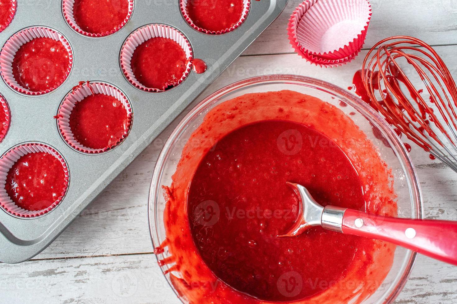 red velvet cake batter with ingredients and cupcake tin flat lay photo