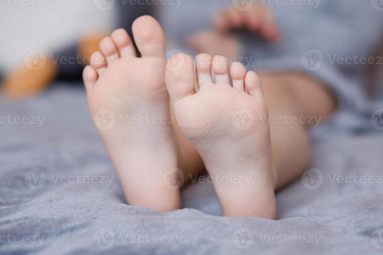 Children's feet are brought together in close-up photo