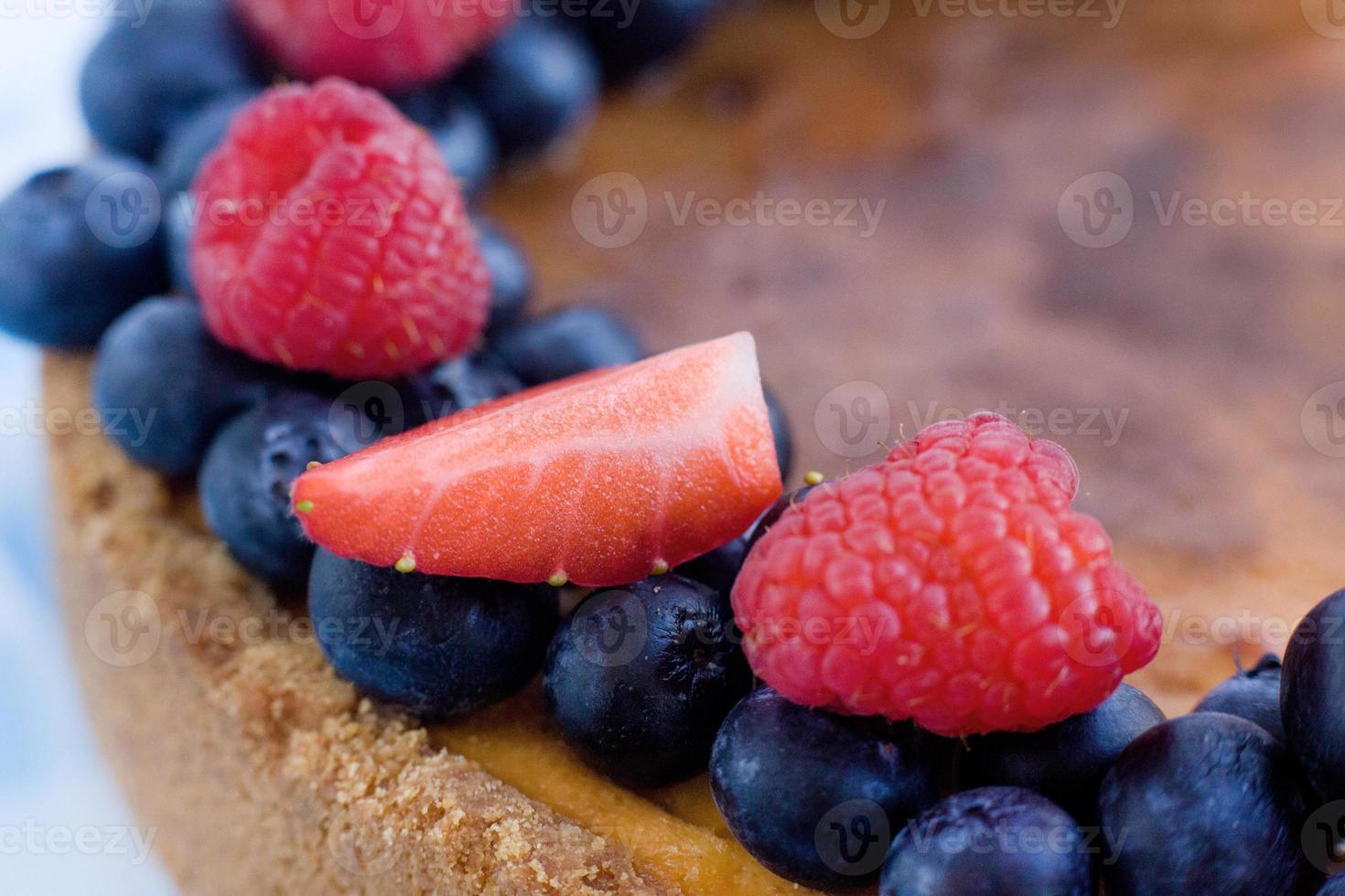 Strawberries, raspberries, blueberries on a pie close-up. Decorating a cake with berries. Berry close-up photo