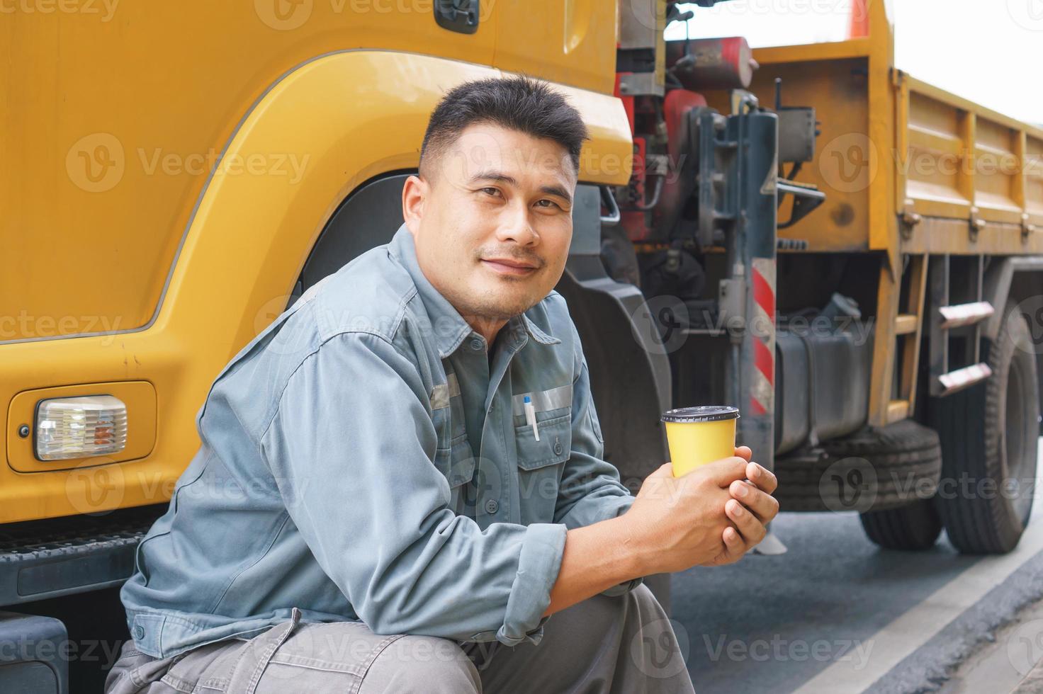 Smile is confident that the truck driver is a mature Asian professional in the transportation and delivery business. photo