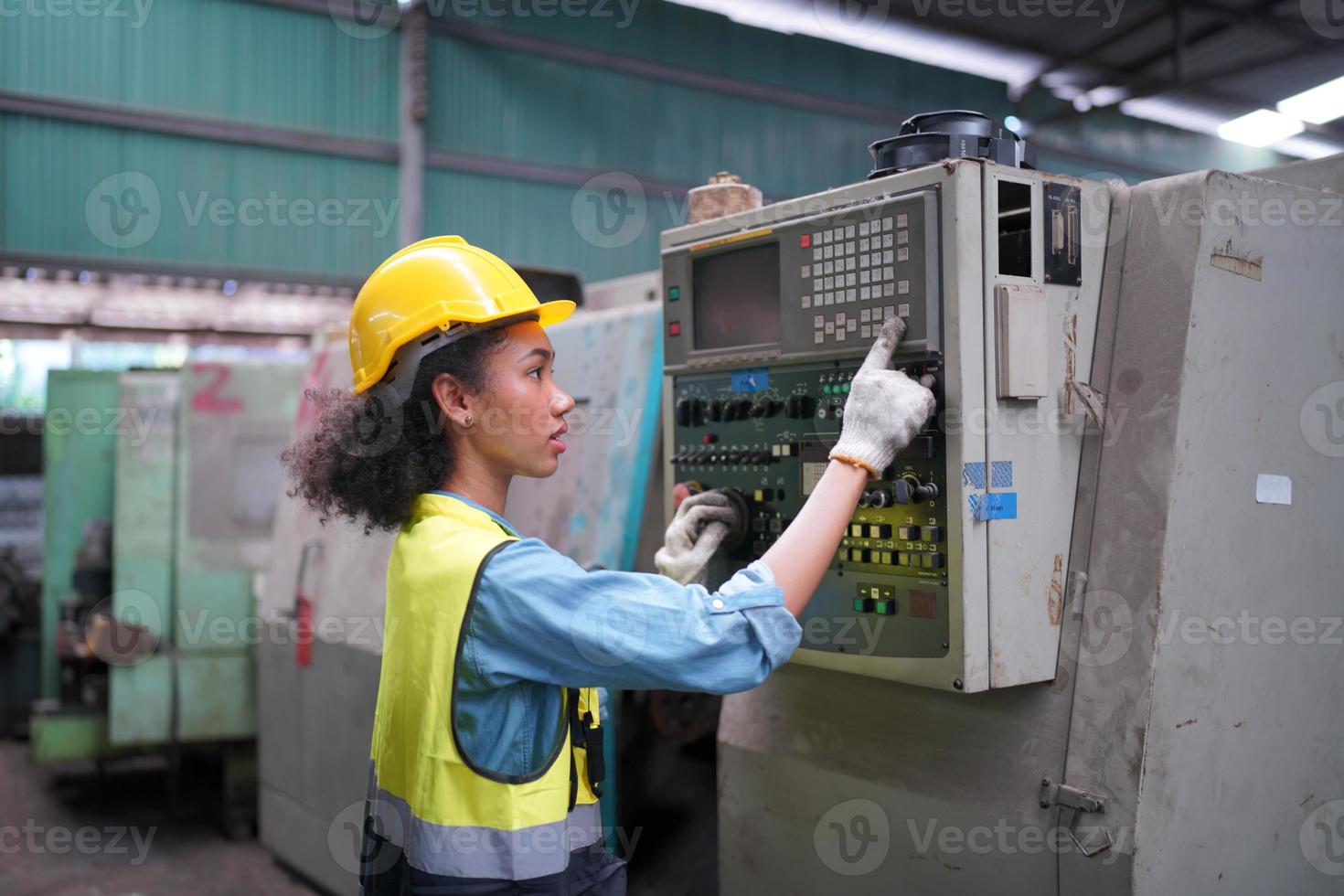 Female Maintenance Engineers is working in front of the automated CNC machinery repair on a maintenance checklist at the production line. photo