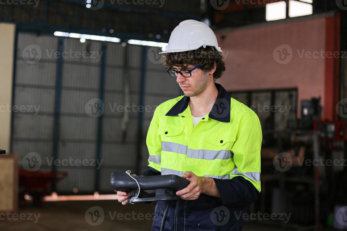 engineer checking control panel and teaching new Automatics robot arm and operating control machine in factory. photo