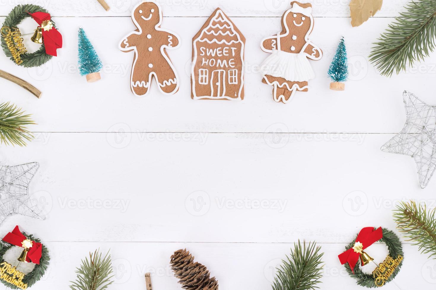 Christmas concept composition decoration objects, fir tree branch wreath, gingerbread man biscuit isolated on white wooden table, top view, flat lay photo