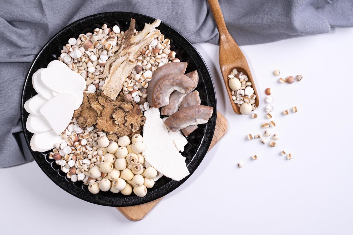 Ingredients of Four Tonics Soup, Four Herb Flavor Soup. Taiwanese traditional food with Job's tears, herbs, pork intestines on white background photo