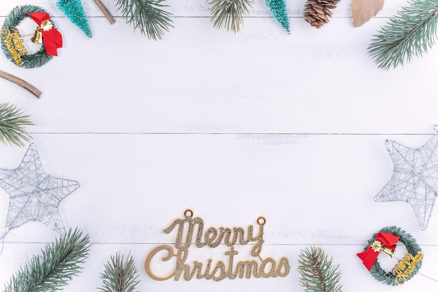 Christmas concept composition decoration objects, fir tree branch wreath and ornament isolated on white wooden table, top view, flat lay, layout up. photo