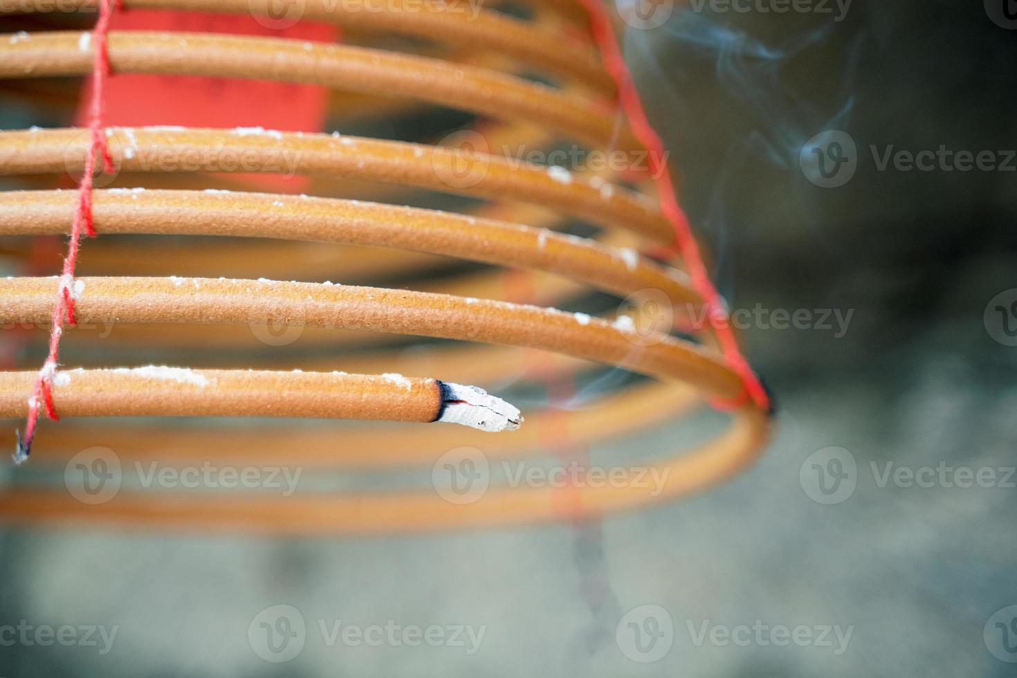 Burned coil swirl incense in Macau Macao temple, traditional Chinese cultural customs to worship god, close up, lifestyle. photo