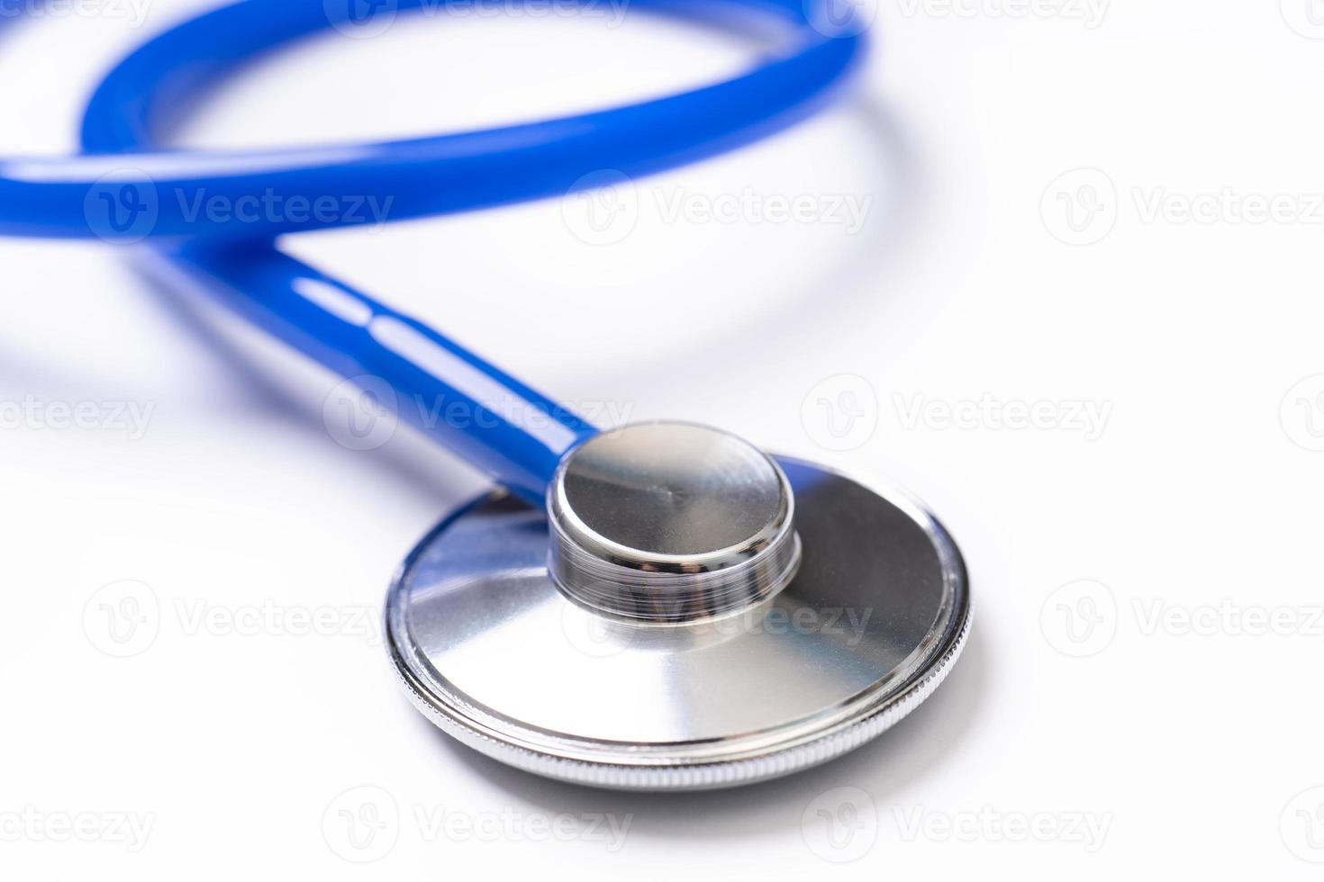 Blue stethoscope,object of doctor equipment for heartbeat trace,isolated on white background. Medical design concept,close up and studio shot. photo