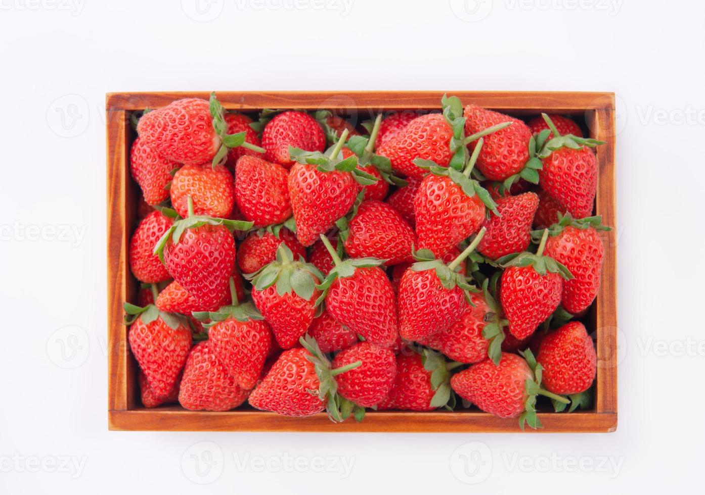 Beautiful and delicious strawberries in a wooden box basket, concept of organic farming, fresh direct delivery from orchard, close up. photo