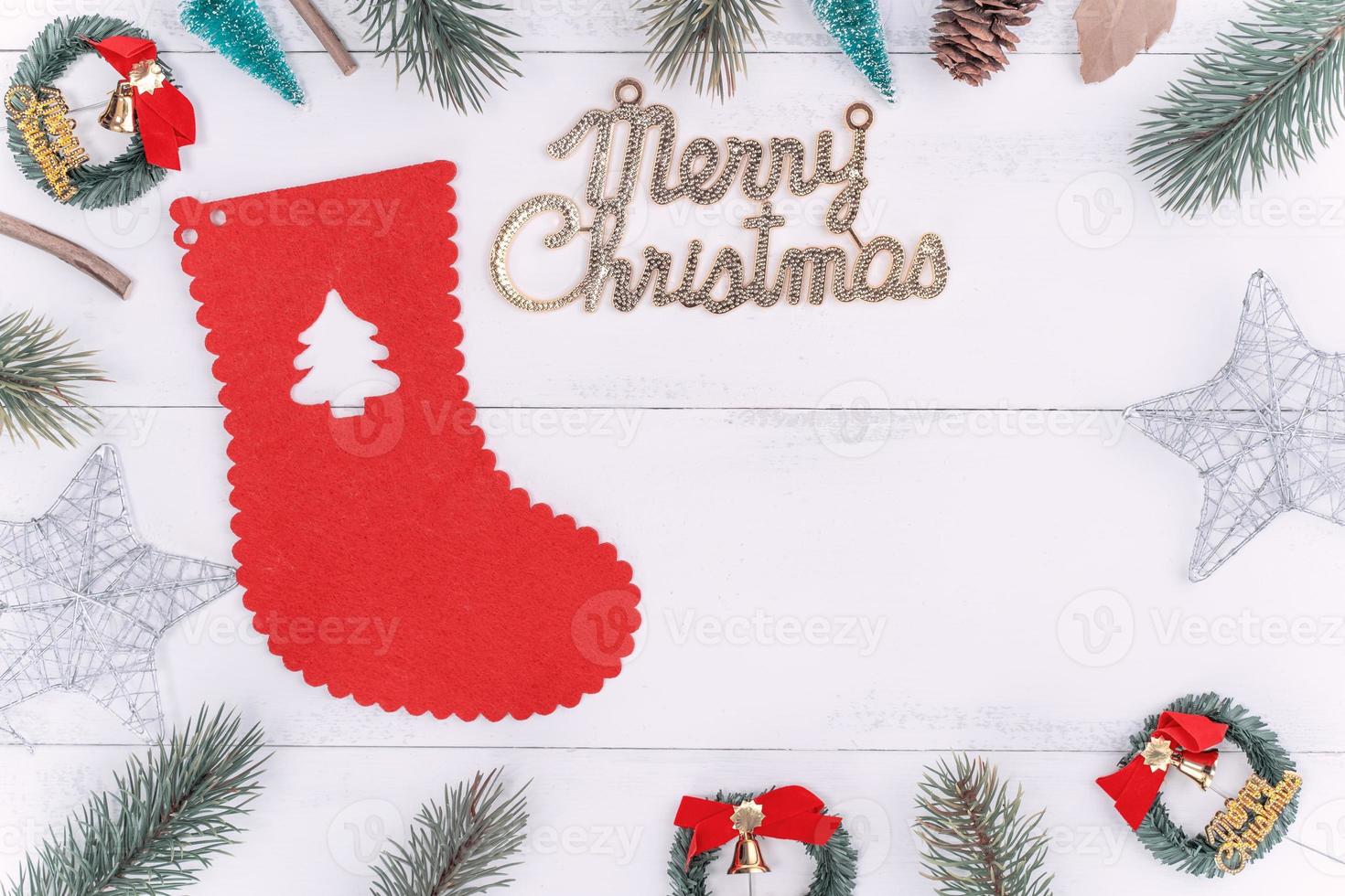 Christmas concept composition decoration objects, fir tree branch wreath and ornament isolated on white wooden table, top view, flat lay, layout up. photo