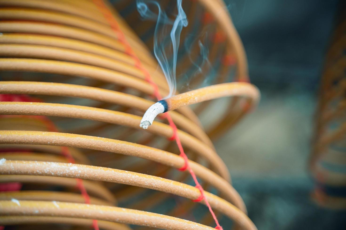 Burned coil swirl incense in Macau Macao temple, traditional Chinese cultural customs to worship god, close up, lifestyle. photo