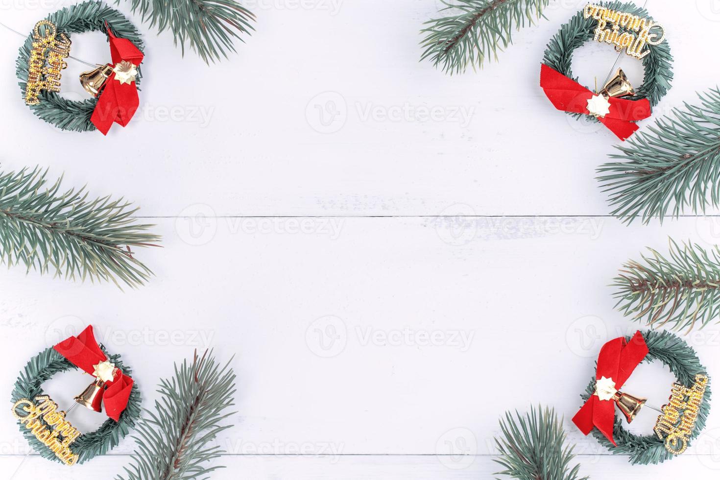 Christmas concept composition decoration objects, fir tree branch wreath and ornament isolated on white wooden table, top view, flat lay, layout up. photo