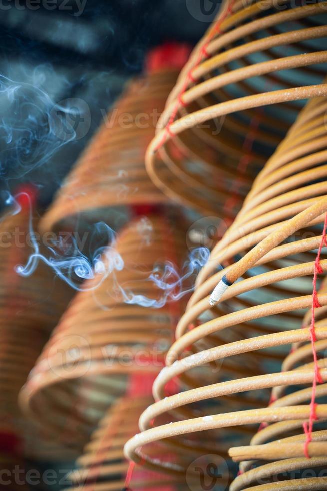 Burned coil swirl incense in Macau Macao temple, traditional Chinese cultural customs to worship god, close up, lifestyle. photo